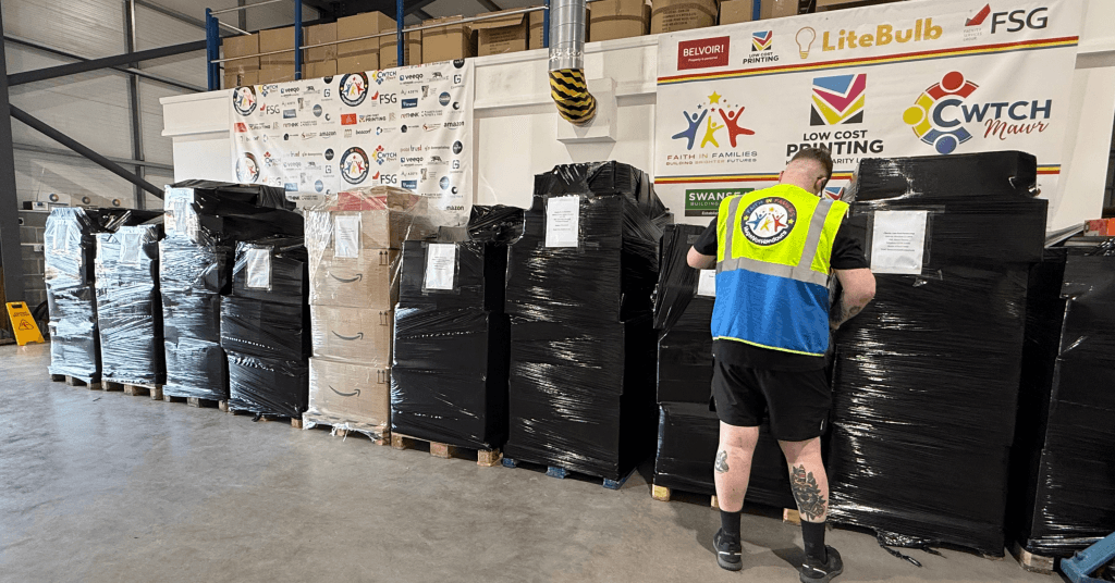 multibank pilot sees a man labelling parge pallets of basic essential goods ready to ship